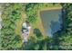 House with pool and pond, surrounded by trees at 1228 Brawley School Rd, Mooresville, NC 28117