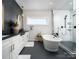 Stylish bathroom featuring a black hexagon tile feature wall and a freestanding tub at 11318 James Coy Rd # Devonshire, Davidson, NC 28036
