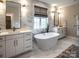 Bright bathroom boasting a freestanding tub, double vanity, and marble tile at 11318 James Coy Rd # Devonshire, Davidson, NC 28036