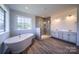 Traditional bathroom with freestanding tub, double vanity, and wood-look flooring at 11318 James Coy Rd # Devonshire, Davidson, NC 28036