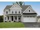 Two story house with gray siding, white trim, and a black metal roof at 11318 James Coy Rd # Devonshire, Davidson, NC 28036