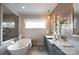Bathroom with soaking tub, double vanity, and a unique mosaic tile feature wall at 11318 James Coy Rd # Devonshire, Davidson, NC 28036