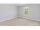 Bright bedroom with carpeted floor and large window at 1030 Heath Helms Rd, Monroe, NC 28110