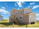 Two-story house exterior with beige siding, wooden deck, and a grassy backyard at 1030 Heath Helms Rd, Monroe, NC 28110