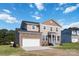 Two-story house with stone and vinyl siding, a white garage door and landscaping at 1030 Heath Helms Rd, Monroe, NC 28110