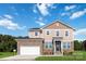 Two-story house with stone and vinyl siding, a white garage door and landscaping at 1030 Heath Helms Rd, Monroe, NC 28110