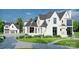 Luxury home exterior rendering with attached garage and fountain at 8014 Litaker Manor Ct, Charlotte, NC 28270