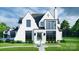 Elegant two-story home with white brick exterior, black roof, and a fountain at 8014 Litaker Manor Ct, Charlotte, NC 28270