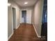 Hallway with wood-look flooring and access to bathroom at 4210 Old Beatty Ford Rd, China Grove, NC 28023