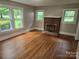 Living room with hardwood floors and a brick fireplace at 4210 Old Beatty Ford Rd, China Grove, NC 28023