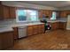 Bright kitchen with wood cabinets, stainless steel appliances, and hardwood floors at 4210 Old Beatty Ford Rd, China Grove, NC 28023