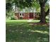 Brick ranch house with covered porch and large tree at 4210 Old Beatty Ford Rd, China Grove, NC 28023