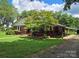 Brick ranch house with covered porch and carport at 4210 Old Beatty Ford Rd, China Grove, NC 28023