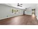 Bright living room with hardwood floors, large windows, and ceiling fans at 506 E Maine Ave, Bessemer City, NC 28016