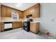 Wood cabinets, black appliances, and linoleum flooring in dated kitchen at 440 N Oakland Ave, Statesville, NC 28677