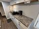 Clean and efficient kitchen with granite countertops and white cabinets at 112 Sycamore St, New London, NC 28127