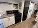 Modern kitchen with black appliances and white cabinets at 112 Sycamore St, New London, NC 28127