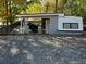 Mobile home with covered patio and outdoor seating area at 112 Sycamore St, New London, NC 28127