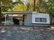 Lake house with covered deck and retro trailer at 112 Sycamore St, New London, NC 28127