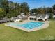 Community pool with clubhouse and surrounding green space at Lot 320 Waterton Trl # Hawthorne, Belmont, NC 28012