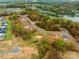 Aerial view showing a community of new homes near a lake at 831 Lake Forest Dr # Savanh, Belmont, NC 28012