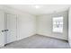 Well-lit bedroom featuring neutral walls and carpet at 8631 Frank Grier Rd # 6, Charlotte, NC 28215