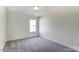Spacious bedroom with neutral carpeting and large window at 8631 Frank Grier Rd # 6, Charlotte, NC 28215