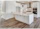 Modern kitchen with white cabinets, large island, stainless steel appliances, and hardwood floors at 8631 Frank Grier Rd # 6, Charlotte, NC 28215