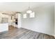 Open dining area with hardwood floors and a chandelier at 8631 Frank Grier Rd # 6, Charlotte, NC 28215
