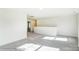 Bright bedroom with grey carpet and hallway access at 8631 Frank Grier Rd # 6, Charlotte, NC 28215