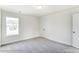 Spacious bedroom with a window, double doors to closet, and grey carpet at 8631 Frank Grier Rd # 6, Charlotte, NC 28215