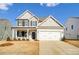 Two-story home with gray siding, white trim, and a two-car garage at 8631 Frank Grier Rd # 6, Charlotte, NC 28215