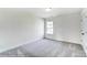 Well-lit bedroom with grey carpet and a window overlooking the backyard at 8631 Frank Grier Rd # 6, Charlotte, NC 28215