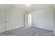Bright bedroom with double doors leading to another room and grey carpet at 8631 Frank Grier Rd # 6, Charlotte, NC 28215