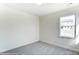 Bright bedroom with grey carpet and a window at 8631 Frank Grier Rd # 6, Charlotte, NC 28215