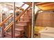 Basement stairs with brown carpeting and wooden railings at 3616 County Home Rd, Conover, NC 28613