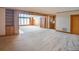 Open living space with built-in shelving and wood paneling at 3616 County Home Rd, Conover, NC 28613