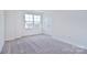Carpeted bedroom with large window and closet at 105 Megby Trl, Statesville, NC 28677