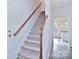 Staircase with wood railing leading to upper level at 105 Megby Trl, Statesville, NC 28677