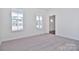 Bright office featuring carpet, two windows, and an entryway at 105 Megby Trl, Statesville, NC 28677