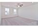 Spacious bedroom with ceiling fan and two large windows at 105 Megby Trl, Statesville, NC 28677