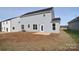 View of the back of a two-story house with gray siding and a patio at 105 Megby Trl, Statesville, NC 28677