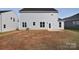 Large backyard with unlandscaped area behind the house at 105 Megby Trl, Statesville, NC 28677