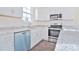 Kitchen with white cabinets, granite counters, and teal dishwasher at 105 Megby Trl, Statesville, NC 28677