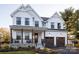 Two-story farmhouse with white siding, brown accents, and a large front porch at 833 Lake Forest Dr # Covington, Belmont, NC 28012