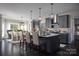 Open kitchen with gray cabinets, a large island, and a spacious dining area at 833 Lake Forest Dr # Covington, Belmont, NC 28012