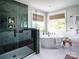 Elegant bathroom with a herringbone tile shower, soaking tub, and modern accents at 833 Lake Forest Dr # Covington, Belmont, NC 28012
