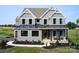 Two-story farmhouse-style home with gray siding, black windows, and metal roof at 833 Lake Forest Dr # Covington, Belmont, NC 28012
