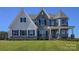 Two-story house with white and gray stone exterior and dark shutters at 843 Lake Forest Dr # Devonshire, Belmont, NC 28012