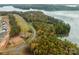 Aerial view of lakefront property with several houses and vacant lots at 833 Lake Forest Dr # Covington, Belmont, NC 28012